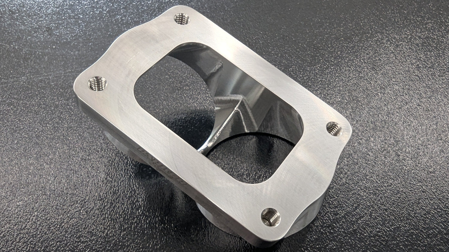 Parker Speed T6 Dual 3 inch canted turbo flange bottom view showing CNC machined dual exhaust ports and mounting holes